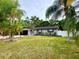 Landscaped single-story home with a spacious yard and black accents at 3143 Phoenix Ave, Oldsmar, FL 34677