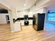 Modern kitchen featuring stainless steel appliances, white cabinets, and black countertop at 3143 Phoenix Ave, Oldsmar, FL 34677