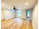 Bright living room boasting beautiful wood floors and a modern ceiling fan at 3143 Phoenix Ave, Oldsmar, FL 34677