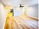 Open-concept living room with beautiful wood floors and contemporary lighting at 3143 Phoenix Ave, Oldsmar, FL 34677