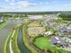 Aerial showing the community's amenities like playgrounds, soccer field, and pool set amongst scenic waterways at 33750 Ocean Spray Ln, Wesley Chapel, FL 33543