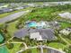 Aerial view of community clubhouse and pool, surrounded by lush landscaping and winding pathways at 33750 Ocean Spray Ln, Wesley Chapel, FL 33543