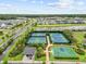 Aerial view of community amenities including tennis courts, basketball court, and scenic landscaping at 33750 Ocean Spray Ln, Wesley Chapel, FL 33543