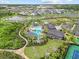 Stunning aerial view of resort-style pool, clubhouse, and lush landscaping in a vibrant community at 33750 Ocean Spray Ln, Wesley Chapel, FL 33543