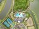 Overhead view of the community amenities, tennis courts, pools and lush greenery bordering a waterway at 33750 Ocean Spray Ln, Wesley Chapel, FL 33543