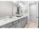 Modern bathroom featuring a double sink vanity, stylish lighting, and decorative artwork at 33750 Ocean Spray Ln, Wesley Chapel, FL 33543