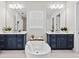 Elegant bathroom with dual vanities, a soaking tub, and sleek fixtures at 33750 Ocean Spray Ln, Wesley Chapel, FL 33543