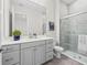 Modern bathroom featuring a glass shower, gray cabinets, and a white countertop at 33750 Ocean Spray Ln, Wesley Chapel, FL 33543