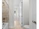 Bathroom showcasing a sleek bathtub, modern fixtures, and a view down a well-lit hallway at 33750 Ocean Spray Ln, Wesley Chapel, FL 33543
