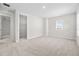 Bright, carpeted bedroom features a walk-in closet and a window letting in natural light at 33750 Ocean Spray Ln, Wesley Chapel, FL 33543