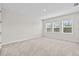 Bright bedroom with three windows offering natural light and a view of the outdoors at 33750 Ocean Spray Ln, Wesley Chapel, FL 33543