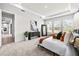 Bright bedroom with a tray ceiling, plush carpet, and ample natural light from the large windows at 33750 Ocean Spray Ln, Wesley Chapel, FL 33543