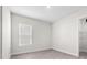 Bedroom with tile flooring, a window, and a walk-in closet at 33750 Ocean Spray Ln, Wesley Chapel, FL 33543