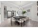 Bright dining room with tray ceilings, chandelier, neutral decor, and an adjacent staircase at 33750 Ocean Spray Ln, Wesley Chapel, FL 33543