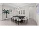 Bright dining room with modern light fixture, neutral décor, and beautiful floors at 33750 Ocean Spray Ln, Wesley Chapel, FL 33543