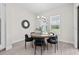Cozy dining room featuring a round table, stylish seating, and ample natural light from the nearby windows at 33750 Ocean Spray Ln, Wesley Chapel, FL 33543
