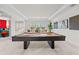 Spacious game room boasts a pool table, neutral decor, and ample natural light at 33750 Ocean Spray Ln, Wesley Chapel, FL 33543