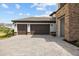 Attached two-car garage with brown doors and a paved driveway at 33750 Ocean Spray Ln, Wesley Chapel, FL 33543