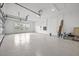 Large, bright garage with epoxy flooring and ample space for vehicles and storage at 33750 Ocean Spray Ln, Wesley Chapel, FL 33543