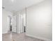 Open hallway with tile flooring, white walls, and multiple doorways at 33750 Ocean Spray Ln, Wesley Chapel, FL 33543