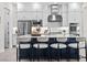 Kitchen features an expansive island with seating, modern appliances, bright white cabinets, and sleek finishes at 33750 Ocean Spray Ln, Wesley Chapel, FL 33543