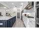 Bright, spacious kitchen with stainless appliances, a large center island with quartz countertops, and a walk-in pantry at 33750 Ocean Spray Ln, Wesley Chapel, FL 33543