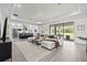 Bright living room featuring an open floor plan with seamless flow into the kitchen and outdoor patio at 33750 Ocean Spray Ln, Wesley Chapel, FL 33543