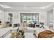 Bright living room boasts a large sectional sofa, stylish decor, and natural light from sliding glass doors to the backyard at 33750 Ocean Spray Ln, Wesley Chapel, FL 33543