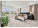 Main bedroom features plush carpet, tray ceilings, large windows, and stylish nightstands with lamps at 33750 Ocean Spray Ln, Wesley Chapel, FL 33543