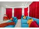 Home theater featuring a blue sectional sofa, red curtains, and a vintage popcorn maker at 33750 Ocean Spray Ln, Wesley Chapel, FL 33543