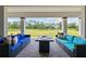 Relaxing covered patio features comfortable seating and a beautiful view of the lush green landscape at 33750 Ocean Spray Ln, Wesley Chapel, FL 33543