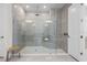 Modern shower with glass enclosure, tiled walls, and sleek fixtures at 33750 Ocean Spray Ln, Wesley Chapel, FL 33543