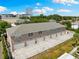 Aerial view of a multifamily building with multiple garages and ample parking space at 3702 W Cass St # 5, Tampa, FL 33609