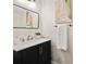 Bathroom featuring a sleek black vanity and a framed rectangular mirror at 3702 W Cass St # 5, Tampa, FL 33609
