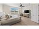 Inviting bedroom featuring a ceiling fan, large window, and wooden dresser with TV at 3702 W Cass St # 5, Tampa, FL 33609
