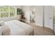 Bright bedroom with bathroom entrance and a large sunlit window view at 3702 W Cass St # 5, Tampa, FL 33609