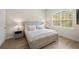 Bright bedroom with large window, hardwood floors, and a white bed at 3702 W Cass St # 5, Tampa, FL 33609