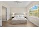 Bright bedroom featuring a king bed, light wood floors, and a large window at 3702 W Cass St # 5, Tampa, FL 33609