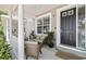 Inviting townhouse front porch with seating and stylish potted plants at 3702 W Cass St # 5, Tampa, FL 33609