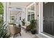 Inviting front porch area features neutral-toned seating, a small table, and potted plants at 3702 W Cass St # 5, Tampa, FL 33609