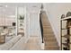 Hallway featuring stairs, kitchen view with breakfast bar, and decorative shelving at 3702 W Cass St # 5, Tampa, FL 33609