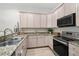 Kitchen featuring stainless steel appliances, granite countertops, and wood cabinets at 3702 W Cass St # 5, Tampa, FL 33609