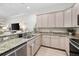 Bright kitchen with stainless steel appliances, granite countertops, and light wood cabinets at 3702 W Cass St # 5, Tampa, FL 33609