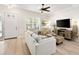 Living room with natural light, neutral tones, light wood floors, and a ceiling fan at 3702 W Cass St # 5, Tampa, FL 33609