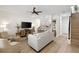 Bright living room with a ceiling fan, light wood floors, and open concept floor plan at 3702 W Cass St # 5, Tampa, FL 33609