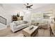 Bright living room with a ceiling fan, light wood floors, and neutral color palette at 3702 W Cass St # 5, Tampa, FL 33609