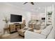 Open-concept living room and kitchen with modern furnishings and recessed lighting at 3702 W Cass St # 5, Tampa, FL 33609