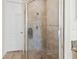 Close-up of a tiled shower with glass door and wall mounted shower head at 3702 W Cass St # 5, Tampa, FL 33609