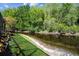 Scenic backyard view with lush greenery and a serene canal, creating a private oasis at 3923 Shoreside Cir, Tampa, FL 33624
