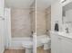 Tiled bathtub shower combination with white shower curtain and white vanity with chrome faucet, great natural light at 3923 Shoreside Cir, Tampa, FL 33624